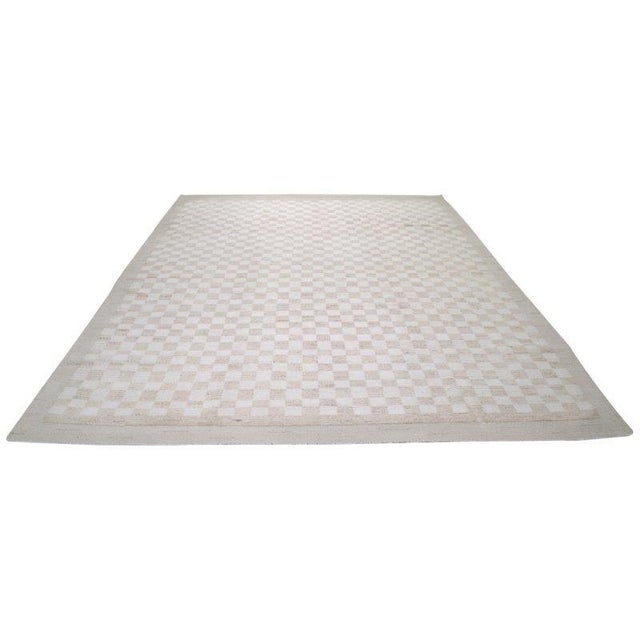 Moroccan hand knotted wool rug with abstract design.