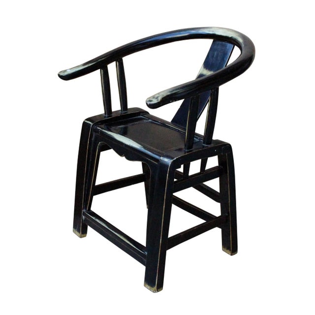 This is a modernized chair with black lacquer surface. The seat back is in simple round curve shape and a few brown...