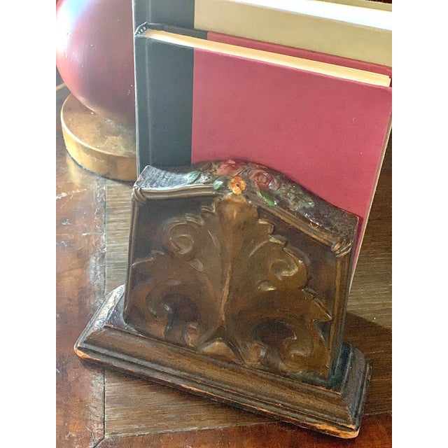 An early 20th century pair of wood Art Nouveau bookends, with a carved flourish on each side and intricately fashioned...
