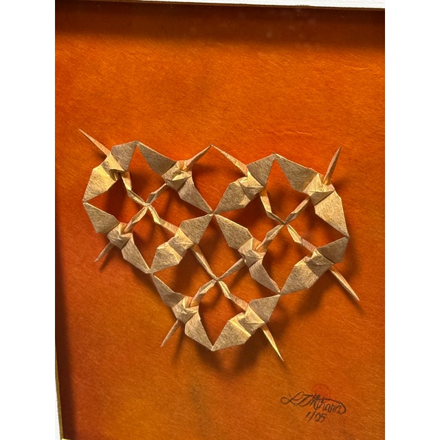 Design Plus Gallery presents Warm Golden Heart by Linda Tomoko Mihara. This is her piece made of multiple origami cranes...