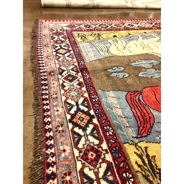 Old Handwoven Shiraz area rug featuring a beautiful pictorial design of four running horses elegantly framed by a...