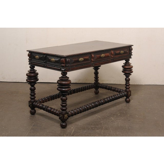 A substantial Portuguese carved rosewood console table from the late 18th to early 19th century. This antique table from...