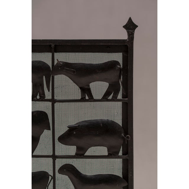 Rare and highly decorative wrought iron fire screen designed by Jean Touret (1916–2004) for Les Artisans de Marolles,...