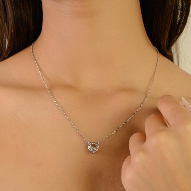 This Heart-Shaped Green Amethyst Pendant Necklace is expertly crafted in 925 Sterling Silver. The pendant showcases a...
