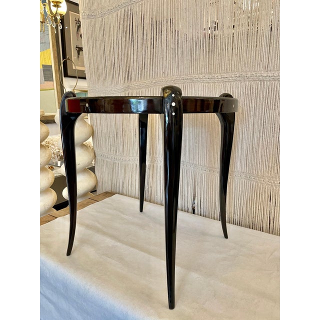 Very much in the style of the Art Deco master, Emile Ruhlmann, this cabriolet leg and round top Macassar wood table by...