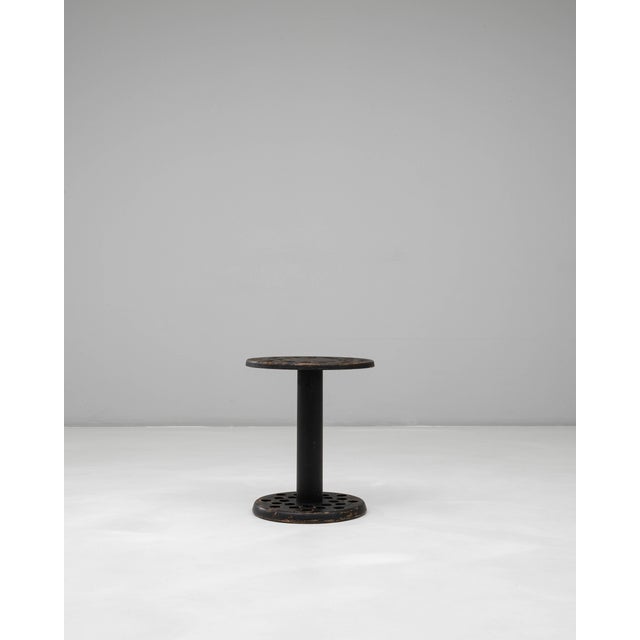 This 20th Century French black-patinated wooden cane stand features a distinctive circular form with a functional,...