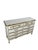 This vintage French Provincial dresser combines an elegant Louis XV-inspired silhouette with a decorative cream-and-gold...