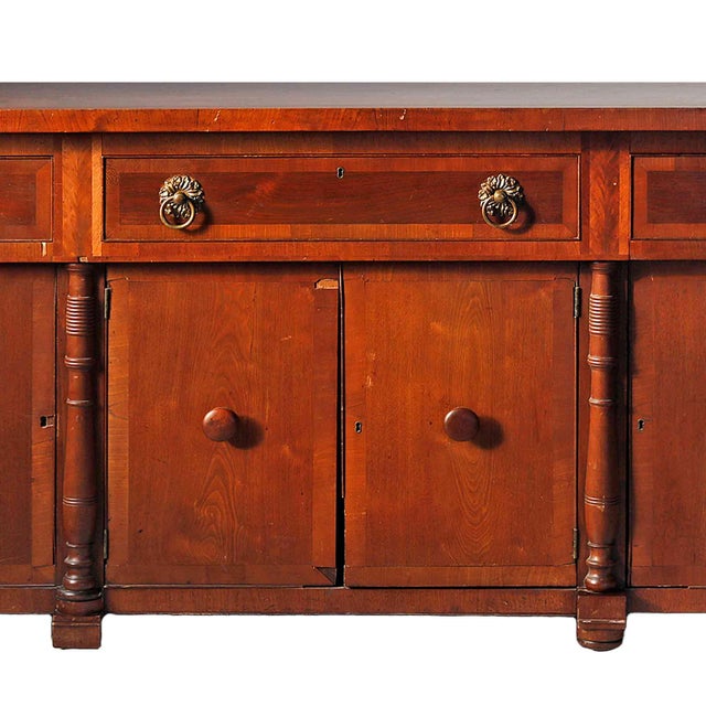 A fine antique American mahogany veneer Sheraton style sideboard. Interior shelves. Circa 1850. Hardware all original. No...
