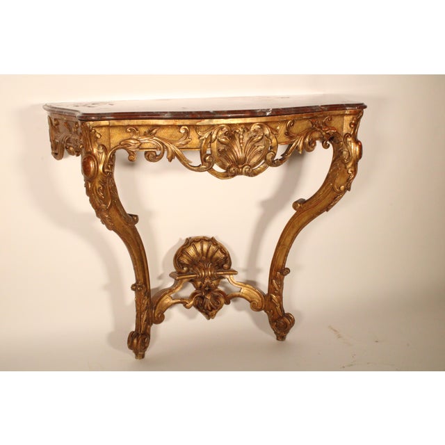Antique Louis XV style gilt wood (gold leaf) marble top console table, late 19th century. With a marble top with molded...