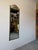 Striking Italian Hollywood Regency wall mirror featuring an elegant arched top adorned with natural shell inlay,...