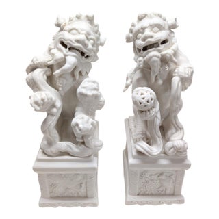 Pair of Vintage Chinese Porcelain Blanc De Chine Foo Dog Statues. For Sale
