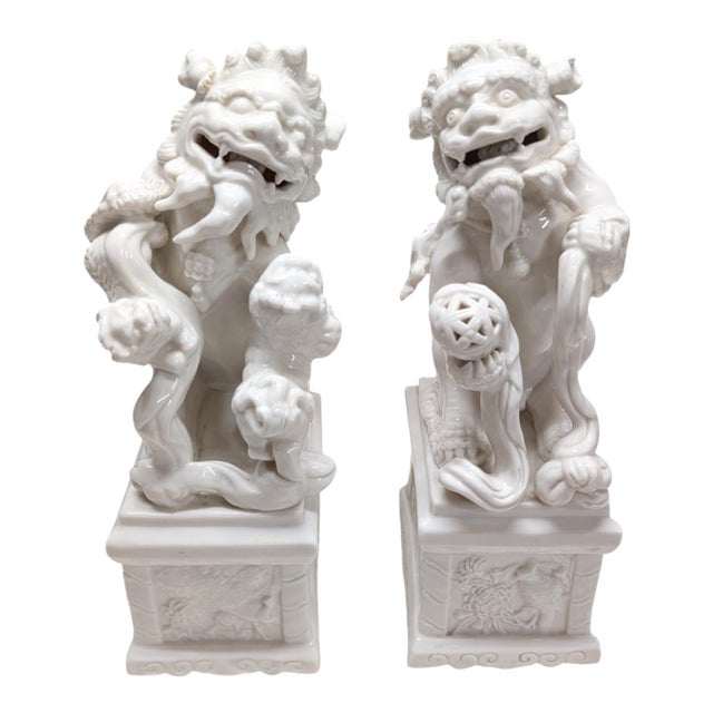 Pair of Vintage Chinese Porcelain Blanc De Chine Foo Dog Statues. For Sale