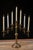 Solid brass seven-light adjustable candelabrum featuring a central standard with pivoting candle arms that expand into an...