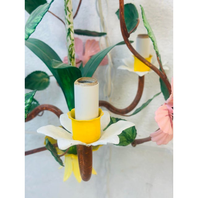 This small chandelier is sculpted as a blooming garden suspended in air. Twisting, vine-like arms in a warm, burnished...