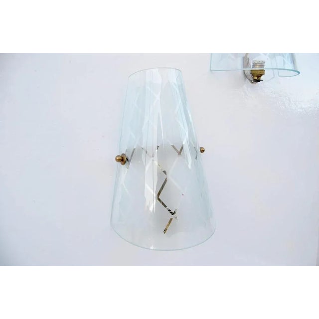 Pair of Appliques from the 1950s, Made in Italy. Note the special feature of blown glass with external grinding. Condition...