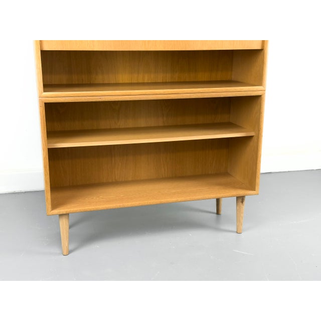 High-quality, two-part cabinet in a minimalist Scandinavian design. The lower section features a shelf with an adjustable...