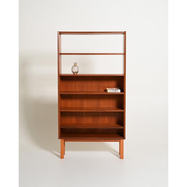 Teak bookcase with adjustable shelves and open upper compartments. Swedish production, 1960s. Made in Sweden in the 1960s,...