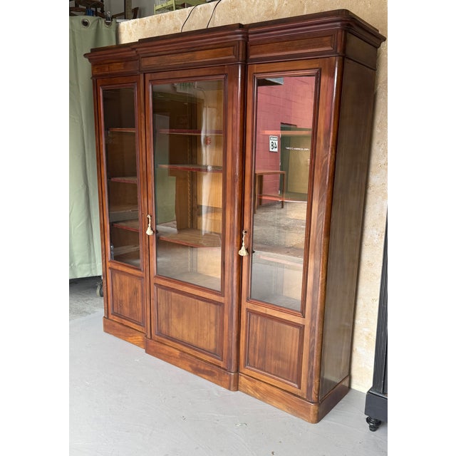 A handsome French late 19th to early 20th century mahogany bookcase of very good quality, featuring three glazed doors...