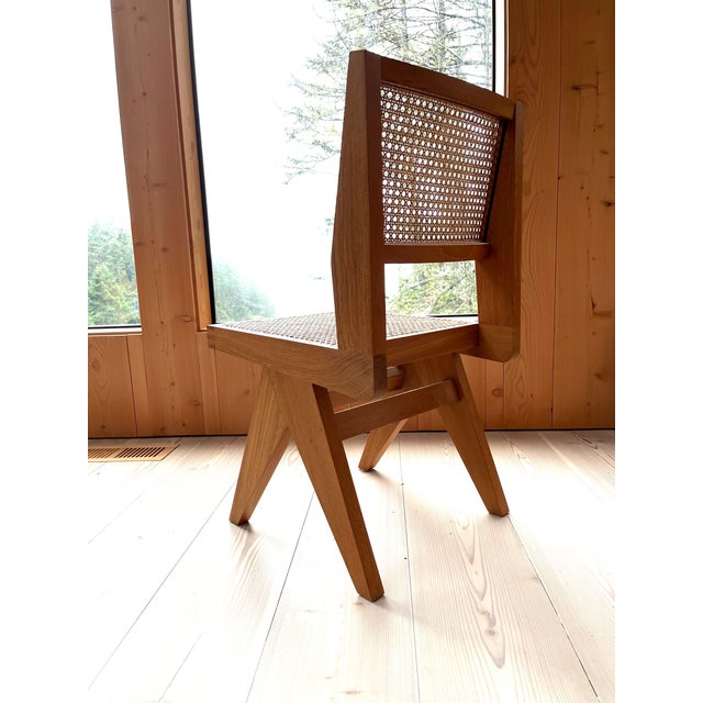 The PHANTOM HANDS Armless Dining Chair is made from solid teak with a natural cane seat and back, with superior...