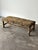 There’s a kind of quiet drama to a piece that hides its bones completely — every inch of this vintage bench, straight...
