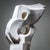 Large white ceramic sculpture of organic, asymmetrical form with dynamic flowing lines and circular piercings reminiscent...