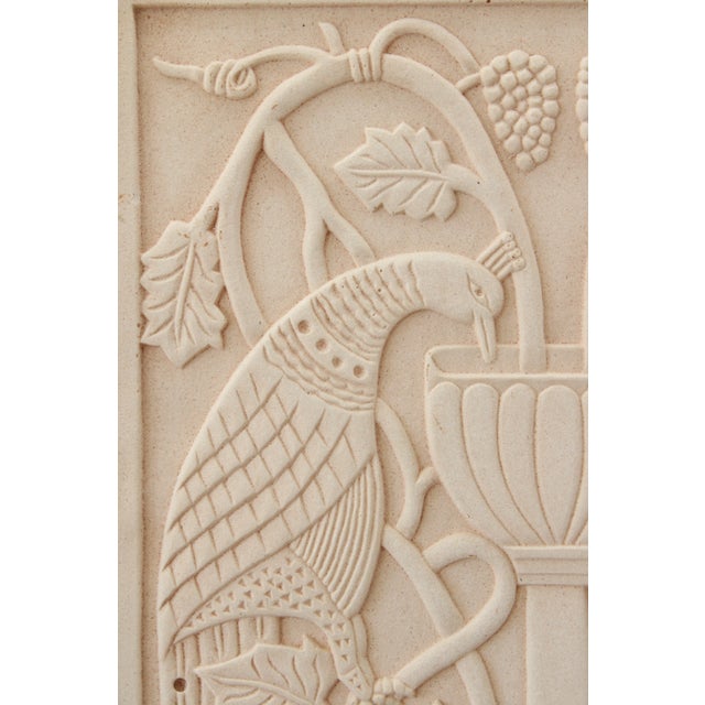 Exceptional sculptural wall relief made of clay. Depicting a grand scale urn flanked by regal peacock's, and trailing...