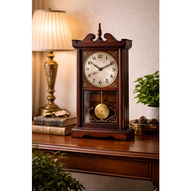 A beautifully composed vintage wall clock featuring a classic 31-day key-wound mechanical movement housed in a richly...