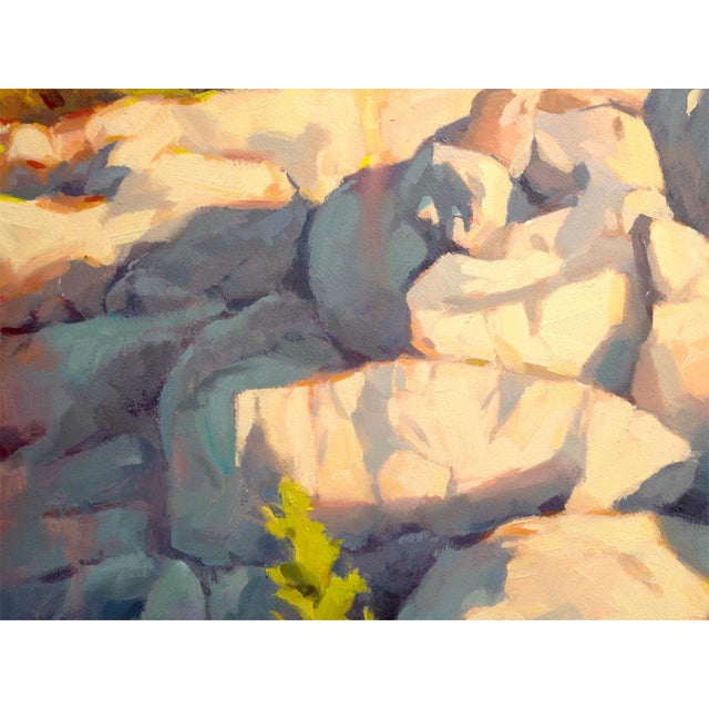 The artwork depicts a rugged rocky landscape bathed in warm sunlight, capturing the intricate textures of the stones and...