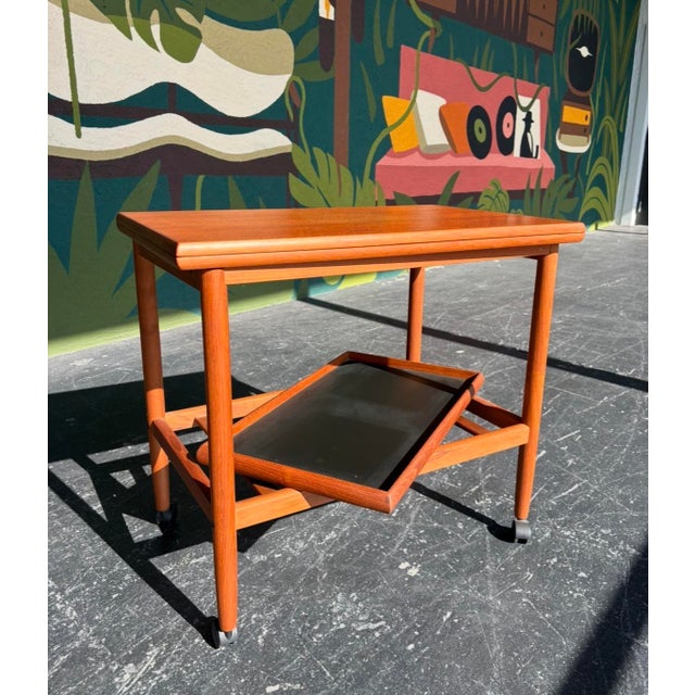 Grete Jalk designed, for Poul Jeppesen, Danish teak expandable bar cart. Perfect for hosting and easy to stowaway when not...