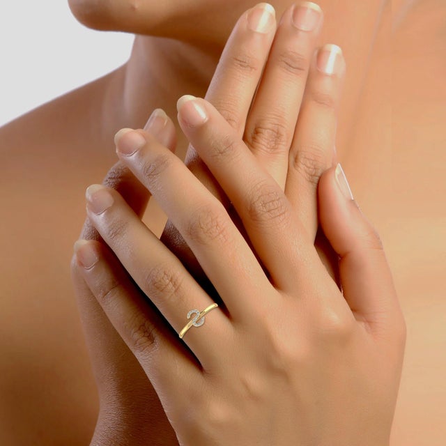 This 10K Yellow Gold Womens Round Diamond S Initial Letter Ring 1/25 Cttw is a refined diamond ring crafted in premium 18K...