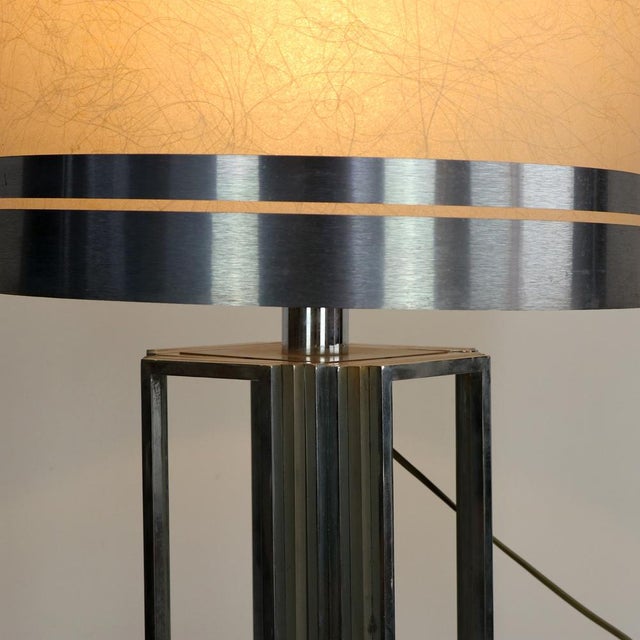 A piece of furniture with extraordinary stage presence and geometric rigor. This monumental table lamp, produced in Italy...