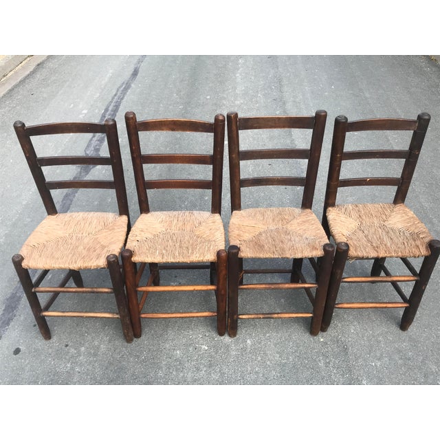 Set of four vintage wooden chairs and straw seats from the 50s the seats are in good general condition the structures as...