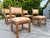 A handsome set of four vintage elephant bamboo dining chairs distinguished by their substantial bamboo frames, wrapped...
