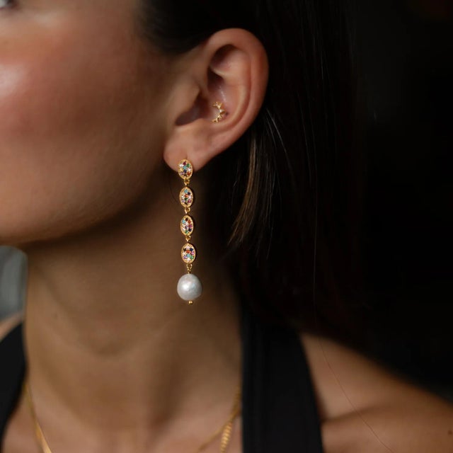 Bring elegance and vibrant energy to your style with the Radiant Gemstone & Pearl Cascade Earrings. Handcrafted in bronze...