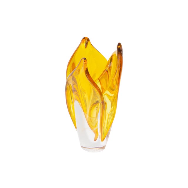 A 2006 art glass vase by American glass artist Steven Webber. This glass is a deep yellow and is in the shape of a flower...