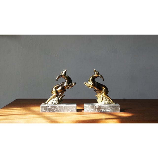 A beautiful pair of French Art Deco period bookends. The bookends have Springbok Antelopes, in jumping pose, set on...