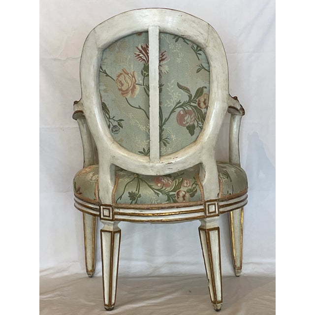 Beautifully hand-carved frame offers generous seat and shaped oval back Legs are tapered and routed. Gilt decoration on...