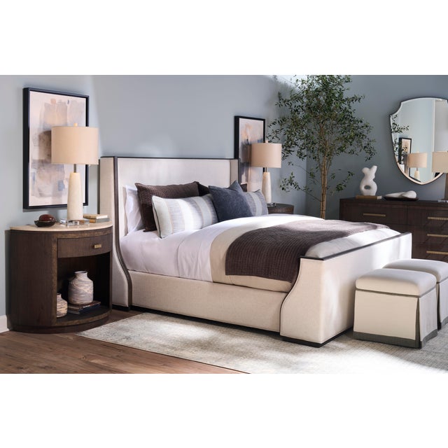 The Monterey bed, shown in a textured, performance linen with a contrasting natural oak wood finish, delivers a...