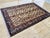 A vintage Afghan rug, hand-knotted in wool in the late 20th century and drawn in the Caucasian tradition, with a repeating...