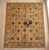 A hand-knotted area rug in the Sultanabad design, woven in Afghanistan on a warm saffron gold ground with pomegranates,...