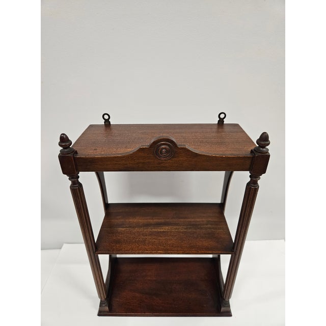 This three tier mahogany etagere or shelf unit can sit atop a table or can be used as a wall mounted unit. The etagere is...