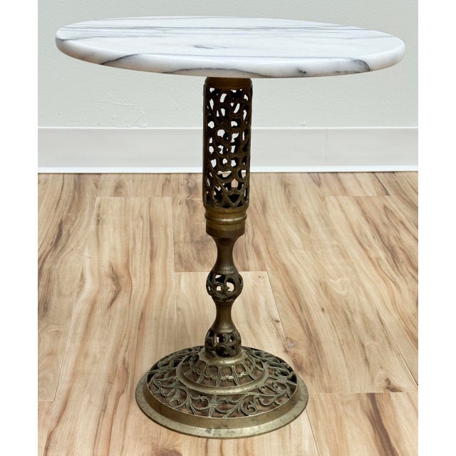 Vintage French style marble top brass filigree base side table. Round marble top with gorgeous veining. Nice patina to...