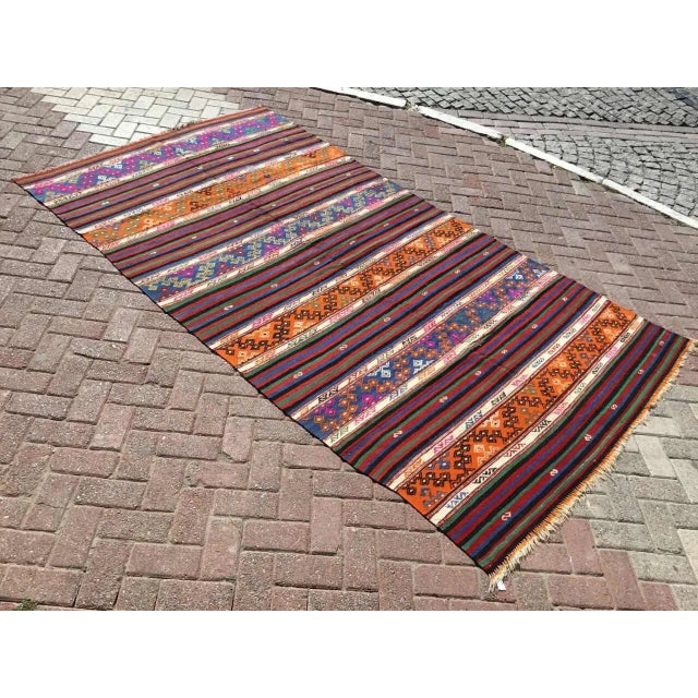 This beautiful vintage handwoven kilim is in fabulous shape. It is approximately 70 years old, handmade of very fine...