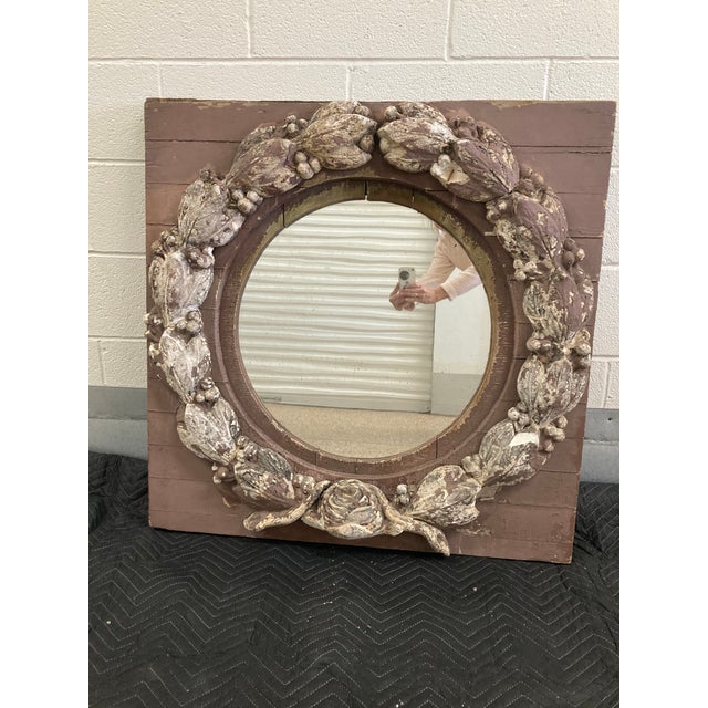 Once belonging to Tory Burch, this unique mirror is a reclaimed wooden window encrusted with an ornate, concrete wreath....