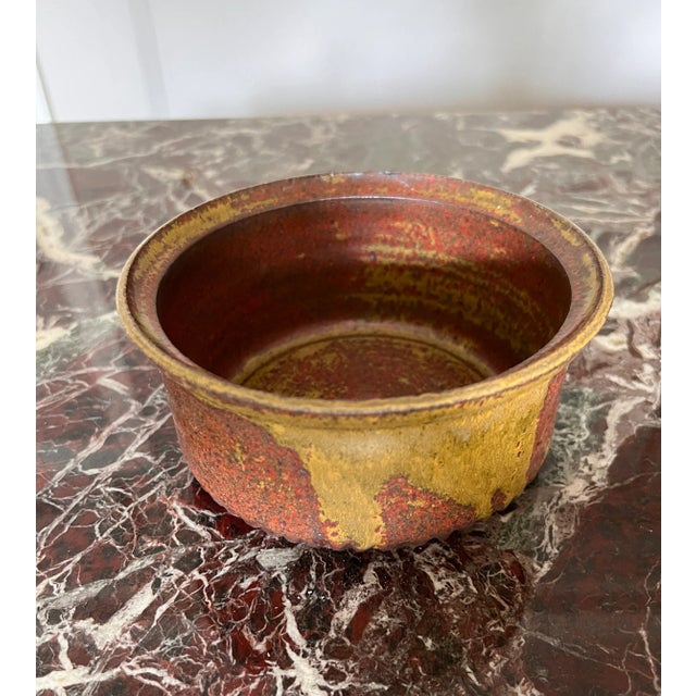 Beautifully glazed ceramic bowl. Green and brown tones play over this nice bowl. It can be used for storage, or display of...