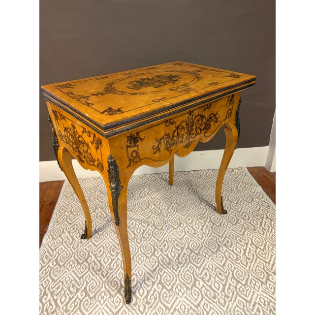 Offered for your consideration, a Louis XV style games table with folding swivel top. This elegant piece features figured...