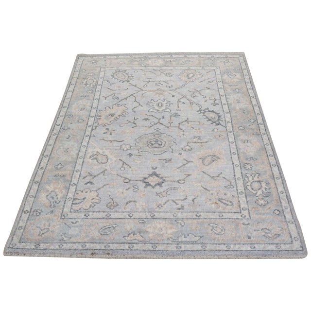 Turkish Oushak Hand-knotted with care using traditional rug-making techniques, this wool rug blends timeless craftsmanship...