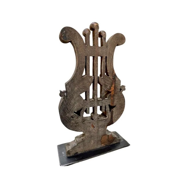 A charming, carved wood architectural piece. Features a vintage style, carved wood lyre/harp on an iron base. Lisa Luby...