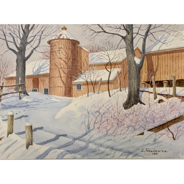 Original watercolor painting depicting a New England barn in a winter landscape. Signed and dated by E. Tomasiewicz 1991....