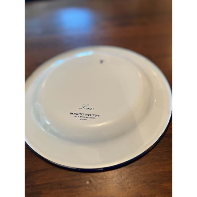Vintage enamelware plate in the Louise pattern by Robert Steffy, San Francisco, dated 1988. Cream background with floral...